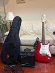 Fender Stratocaster Squier With Amplifier, Case, Cables, Strap, And Picks. Fixed Price $350.00.