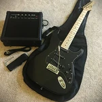 Full-size Black Electric Guitar Starter Package With 20-WATT Amp And Accessories. Fixed Price $99.99.